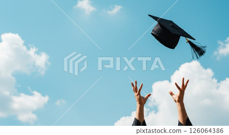 Cap toss signifies student freedom. Sky backdrop enhances this freedom. Pure freedom 126064386