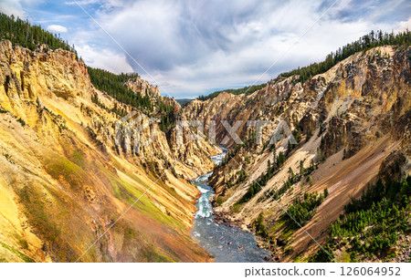 Colorful cliffs and winding river carve through the dramatic Grand Canyon of the Yellowstone, showcasing geothermal hues and rugged terrain in Yellowstone National Park, Wyoming, United States Colorful cliffs and winding river carve through the dramatic Grand Canyon of the Yellowstone, showcasing geothermal hues and rugged terrain in Yellowstone National Park, Wyoming, United States 126064952