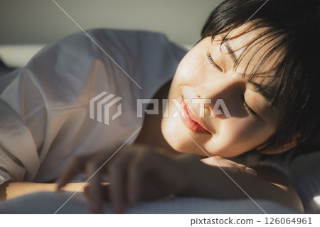 A woman relaxing in bed 126064961