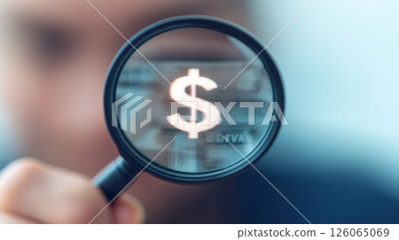 Businessman holding magnifying glass showing dollar symbol reflecting banknote 126065069