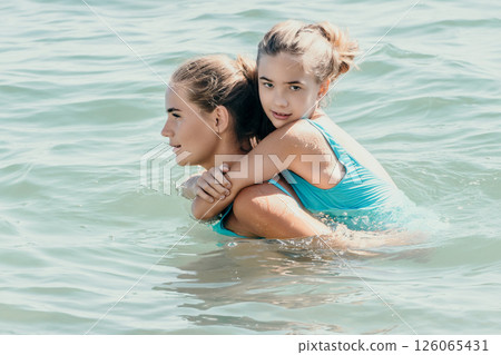 Mother and Daughter Enjoying a Day at the Beach Mother and Daughter Enjoying a Day at the Beach 126065431