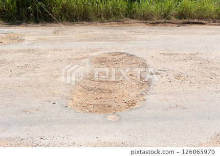 Asphalt road surface crack or damage. 126065970