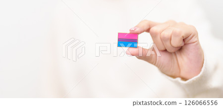 Bisexuality Celebrate Day and LGBT pride month, LGBTQ or LGBTQIA concept. Hand holding purple, pink and blue flag shape for Lesbian, Gay, Bisexual, Transgender, Queer, Pansexual, Marriage Equality Law Bisexuality Celebrate Day and LGBT pride month, LGBTQ or LGBTQIA concept. Hand holding purple, pink and blue flag shape for Lesbian, Gay, Bisexual, Transgender, Queer, Pansexual, Marriage Equality Law 126066556