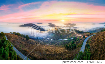 Panoramic of Golden morning sunlight pierces the foggy over mountain, Chiang mai. Panoramic of Golden morning sunlight pierces the foggy over mountain, Chiang mai. 126066642