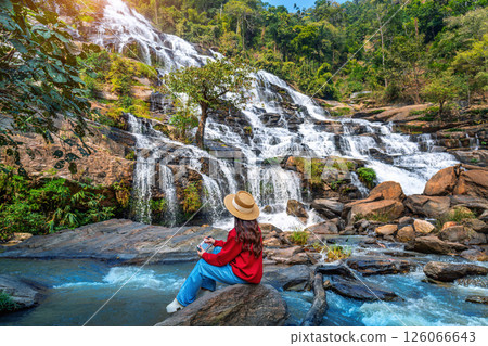 Tourist taking a photo and enjoy nature landscape at Mae ya waterfall, Chiang mai. 126066643