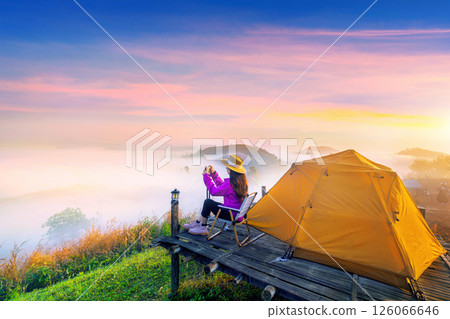 Tourist taking a photo and enjoy nature panoramic landscape at foggy over mountain, Chiang mai, Thailand. Tourist taking a photo and enjoy nature panoramic landscape at foggy over mountain, Chiang mai, Thailand. 126066646