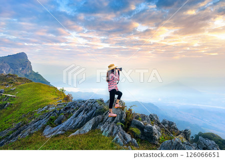 Tourist taking a photo and enjoy nature panoramic landscape at Doi pha mon mountains in Chiang rai, Thailand. 126066651
