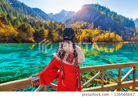 Tourist wearing traditional clothes at jiuzhaigou national park in autumn, Sichuan, China. 126066687