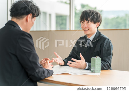 Young Asian businessman in work clothes having a meeting for a building or tenant negotiation Young Asian businessman in work clothes having a meeting for a building or tenant negotiation 126066795