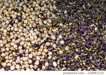 Peeled hazelnuts and pistachios top view. Nuts background. 126067219