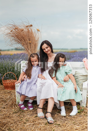 A mother with two daughters in a lavender field.  126067353