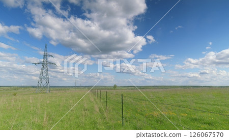 Power Lines Against a Beautiful and Scenic Sky Filled with Ethereal Clouds and Sunlight Time lapse. Power Lines Against a Beautiful and Scenic Sky Filled with Ethereal Clouds and Sunlight Time lapse. 126067570