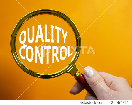 Quality Control symbol. Magnifying glass with words Quality Control. Beautiful orange background. Businessman hand. Business and Quality Control concept. Copy space. Quality Control symbol. Magnifying glass with words Quality Control. Beautiful orange background. Businessman hand. Business and Quality Control concept. Copy space. 126067765