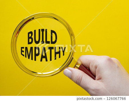 Build empathy symbol. Magnifying glass with words Build empathy. Beautiful yellow background. Businessman hand. Business and Build empathy concept. Copy space. Build empathy symbol. Magnifying glass with words Build empathy. Beautiful yellow background. Businessman hand. Business and Build empathy concept. Copy space. 126067766