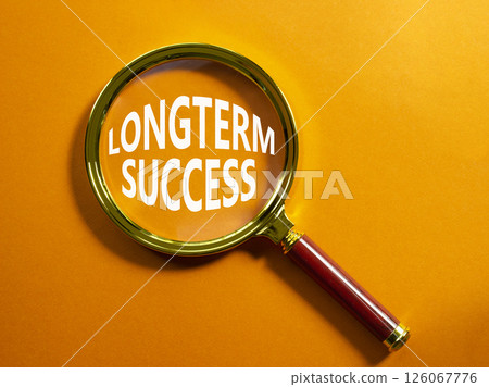 Longterm success symbol. Magnifying Glass with Concept word Longterm success. Beautiful orange background. Business and Longterm success concept. Copy space Longterm success symbol. Magnifying Glass with Concept word Longterm success. Beautiful orange background. Business and Longterm success concept. Copy space 126067776
