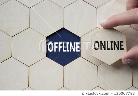 Offline or Online symbol. Concept word Offline or Online on wooden comb puzzle. Businessman hand. Beautiful deep blue background. Business and Offline or Online concept. Copy space 126067788
