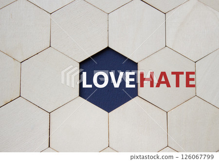 Love vs Hate symbol. Concept word Love vs Hate on wooden comb puzzle. Beautiful deep blue background. Business and Love vs Hate concept. Copy space Love vs Hate symbol. Concept word Love vs Hate on wooden comb puzzle. Beautiful deep blue background. Business and Love vs Hate concept. Copy space 126067799