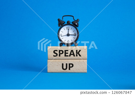 Speak Up symbol. Wooden blocks with words Speak Up Beautiful blue background with alarm clock. Business and Speak Up concept. Copy space. 126067847
