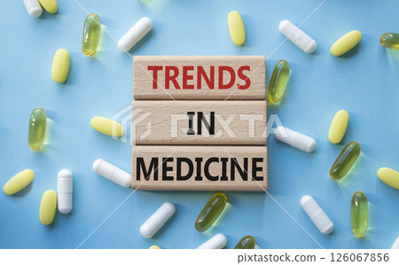 Medicine symbol. Concept words Trends in Medicine on wooden blocks. Beautiful blue background with pills. Medicine concept and Trends in Medicine. Copy space 126067856