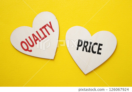 Price or Quality symbol. Concept word Price or Quality on wooden hearts. Beautiful yellow background. Business and Price or Quality concept. Copy space Price or Quality symbol. Concept word Price or Quality on wooden hearts. Beautiful yellow background. Business and Price or Quality concept. Copy space 126067924