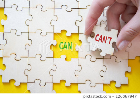 Can or Cant symbol. Concept word Can or Cant on wooden puzzle. Businessman hand. Beautiful yellow background. Business and Can or Cant concept. Copy space 126067947