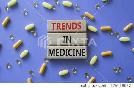 Medicine symbol. Concept words Trends in Medicine on wooden blocks. Beautiful purple background with pills. Medicine concept and Trends in Medicine. Copy space Medicine symbol. Concept words Trends in Medicine on wooden blocks. Beautiful purple background with pills. Medicine concept and Trends in Medicine. Copy space 126068027