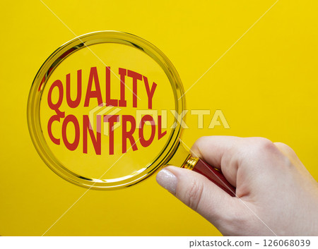 Quality Control symbol. Magnifying glass with words Quality Control. Beautiful yellow background. Businessman hand. Business and Quality Control concept. Copy space. 126068039