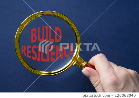 Build resilience symbol. Magnifying glass with words Build resilience. Beautiful deep blue background. Businessman hand. Business and Build resilience concept. Copy space. Build resilience symbol. Magnifying glass with words Build resilience. Beautiful deep blue background. Businessman hand. Business and Build resilience concept. Copy space. 126068040