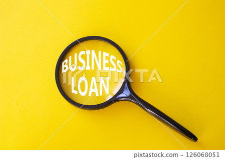 Business loan symbol. Magnifying glass with words Business loan. Beautiful yellow background. Business and Business loan concept. Copy space. 126068051