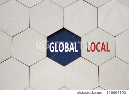 Global and Local symbol. Concept word Global and Local on wooden comb puzzle. Beautiful deep blue background. Business and Global and Local concept. Copy space 126068100