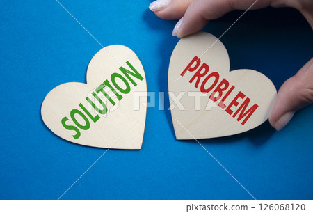 Solution vs Problem symbol. Concept word Solution vs Problem on wooden hearts. Businessman hand. Beautiful blue background. Business and Solution vs Problem concept. Copy space Solution vs Problem symbol. Concept word Solution vs Problem on wooden hearts. Businessman hand. Beautiful blue background. Business and Solution vs Problem concept. Copy space 126068120