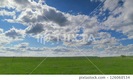 The Serene Green Fields Stretch Elegantly Underneath a Stunningly Beautiful Cloudy Sky Time lapse. The Serene Green Fields Stretch Elegantly Underneath a Stunningly Beautiful Cloudy Sky Time lapse. 126068534