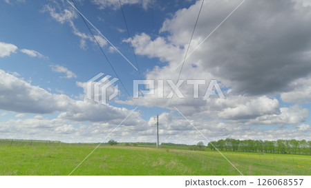 A breathtaking and picturesque landscape showcases power lines beneath a dynamic and vibrant sky Time lapse. A breathtaking and picturesque landscape showcases power lines beneath a dynamic and vibrant sky Time lapse. 126068557
