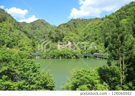 Iida Line local train 10 running along Hiraoka Dam Lake 126068982