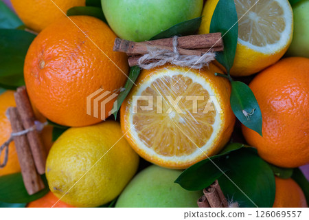Creative layout of apples, orange, lemon, cinnamon sticks. Flat layout. The concept of food. A macro concept. Creative layout of apples, orange, lemon, cinnamon sticks. Flat layout. The concept of food. A macro concept. 126069557