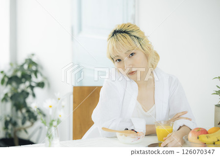 Breakfast: Woman eating yogurt Breakfast: Woman eating yogurt 126070347