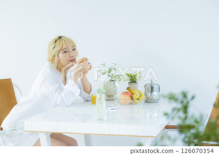 Breakfast: Woman eating yogurt Breakfast: Woman eating yogurt 126070354