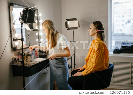 Makeup Artist Applying Foundation to Client in Salon Makeup Artist Applying Foundation to Client in Salon 126071120