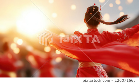 woman in red traditional dress dances gracefully, surrounded by glowing lights during festive celebration. vibrant colors and joyful atmosphere create captivating scene 126071663