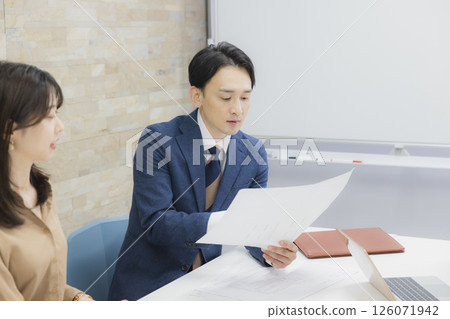 People having a meeting in a conference room People having a meeting in a conference room 126071942