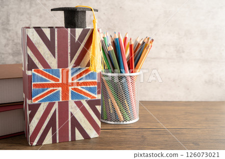 UK flag with graduate hat on english language book. 126073021