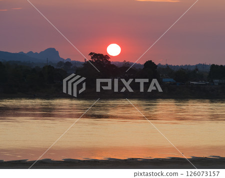 Nakhon Phanom, Thailand - Sunrise over the Mekong River and the mountain ranges of Laos 126073157