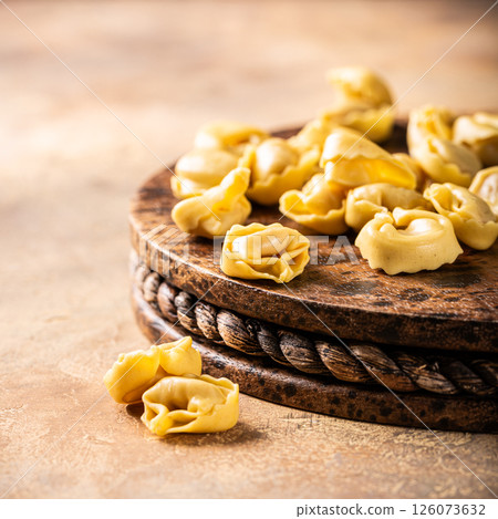 Fresh Tortellini Cappelletti Pasta on Wooden Board Fresh Tortellini Cappelletti Pasta on Wooden Board 126073632