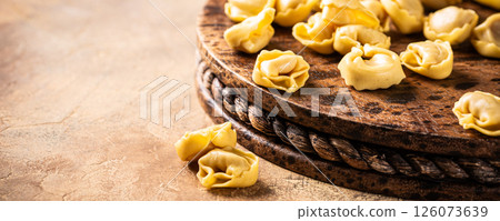 Fresh Tortellini Cappelletti Pasta on Wooden Board Fresh Tortellini Cappelletti Pasta on Wooden Board 126073639