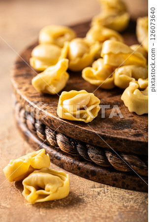 Fresh Tortellini Cappelletti Pasta on Wooden Board 126073640