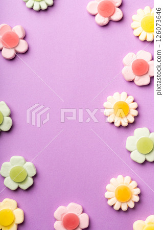 Colorful Flower-Shaped Gummy Candies on Purple Background Colorful Flower-Shaped Gummy Candies on Purple Background 126073646