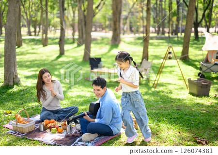 Family spending quality time together at a sunny campsite Family spending quality time together at a sunny campsite 126074381