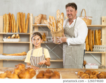 Father and little daughter - selling bread and various baguettes for sale Father and little daughter - selling bread and various baguettes for sale 126074680