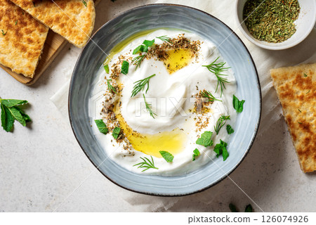 Labneh yogurt cream cheese with olive oil, herbs and zaatar Labneh yogurt cream cheese with olive oil, herbs and zaatar 126074926