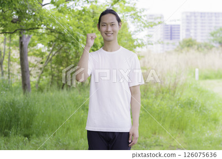 Portrait of a young man posing in a park 126075636